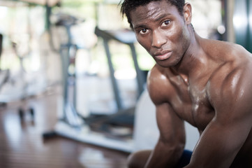 muscled black athlete looking at camera