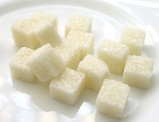 close up of sugar cubes on white plate