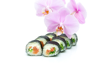 sushi and blooming orchid on a white background. horizontal phot