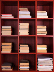 Books on a brown shelf