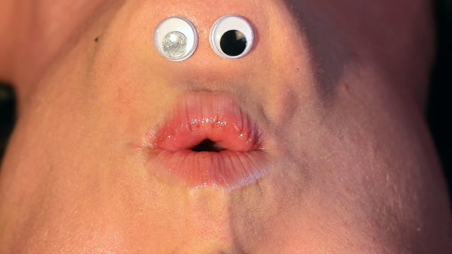 Mrs Chinigan whistles.  Cartoon eyes on inverted female face.
