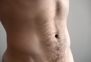 Flat man's belly. Closeup photo with shallow depth of field