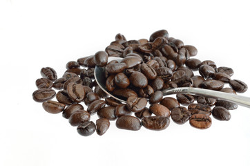 Coffee beans and silver spoon isolated on white