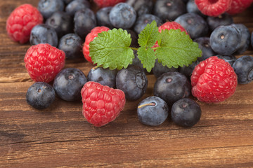 Blueberries with raspberries on wood IV