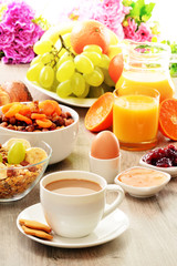 Breakfast including coffee, bread, honey, orange juice, muesli a