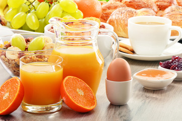 Breakfast including coffee, bread, honey, orange juice, muesli a