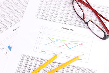 Documents, calculator and glasses close-up.