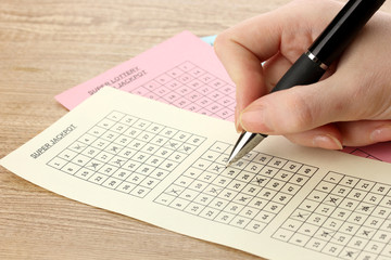 Obraz premium Closeup of lotto ticket during the marking of numbers,