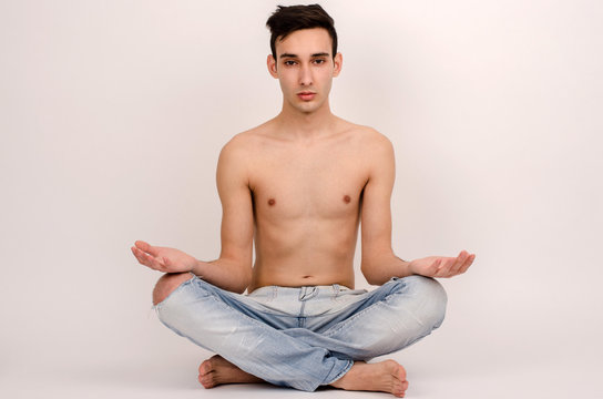 Young man doing yoga. Man staying in a yoga position.