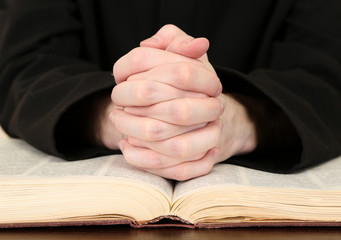 Priest reading from the holy bible, close up