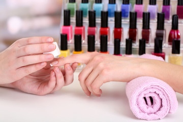 Manicure process in beauty salon, close up