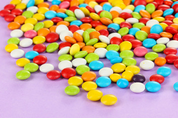 Fototapeta na wymiar Colorful candies on lilac background
