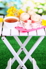 Beautiful composition with cup of tea and marshmallow