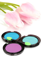 Bright eye shadows and sponge brushes for foundation close up