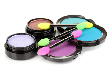 Bright eye shadows and sponge brushes for foundation isolated
