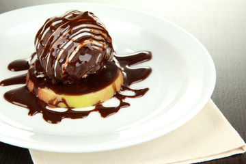 Chocolate dessert on big plate close up