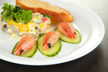 Small portion of food on big plate on wooden table