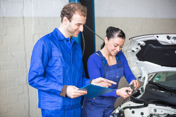 Car mechanics repairing the electrics