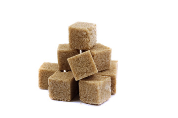 Pyramid of brown lump sugar on a white background