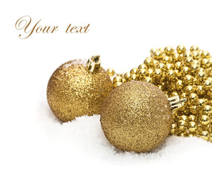 gold christmas balls with snow isolated on white