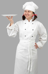 Woman chef holding a white plate