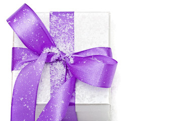White gift box, lilac bow with snow on white background