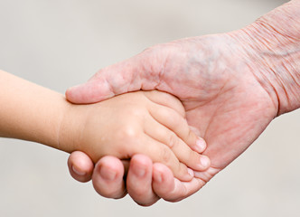 hands of a grandmother and child