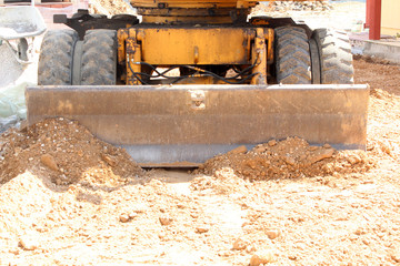 old digger pushing the soil in front of him