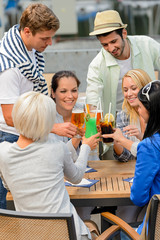 Group of cheerful people toasting with cocktails