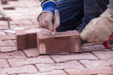 marking with a pencil on a brick paver, before CUTTING