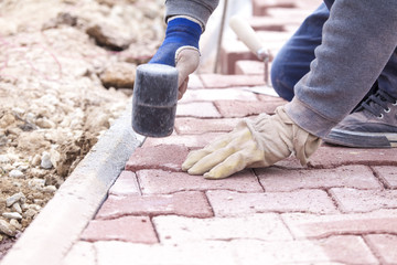 Paver bricks settings by rubber hammer