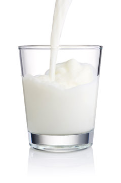 Pouring a Fresh Glass of Milk isolated on white background