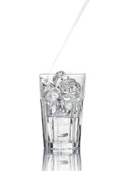 Glass of pouring water with ice