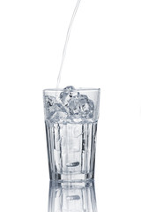 Glass of pouring water with ice
