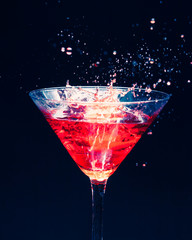 red splashing cocktail on black