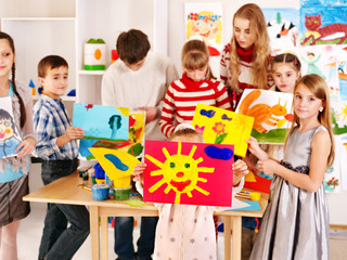 Child painting at art school.