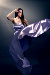 Beautiful fashion woman in violet long dress