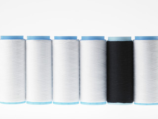 White on white, spools of thread on white background
