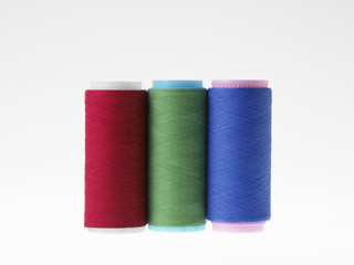Colors, spools of thread on a white background
