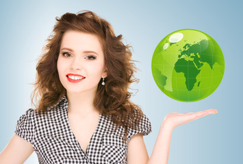 woman holding green globe on her hand