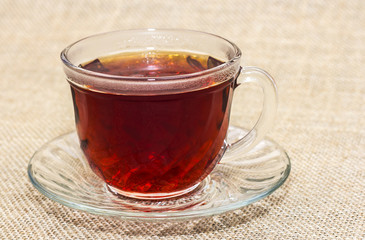 cup of black tea on a burlap background