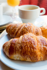 Breakfast with coffee and croissants
