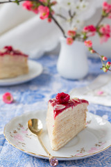 Piece of mascarpone crepe cake with berry sauce