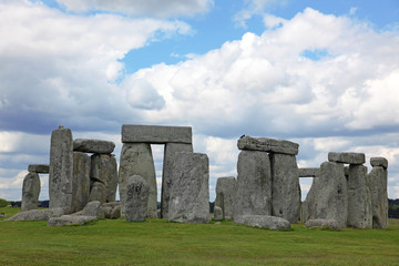 Stonehenge historic site on green grass under blue sky. Stonehen