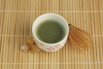 Japanese green tea on bamboo mat.