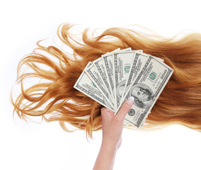 money and curly brown hair over white, dollars bills - 50799453