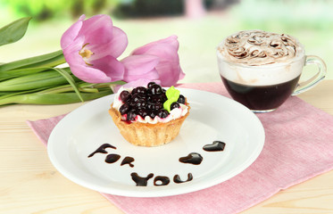Sweet cake with blackberry and chocolate sauce
