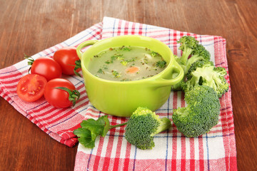 Diet soup with vegetables in pan on wooden table close-up