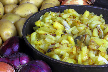 roasted potatos with background potatos and onions