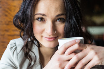 Young Woman Holding a Cup of Hot Beverage